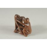 A CARVED WOOD EROTIC NETUKE. Signed. 1.5ins.