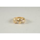 A 14CT GOLD FOUR STONE DIAMOND RING