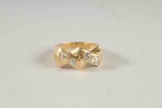 A 14CT GOLD FOUR STONE DIAMOND RING