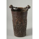 A RARE BRONZE HOLY WATER STOUP the sides cast with religous figures. 7ins high.