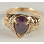 A 14CT GOLD AMETHYST AND DIAMOND RING.