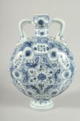 A CHINESE BLUE AND WHITE PORCELAIN TWIN HANDLED MOON FLASK. 28ins high.