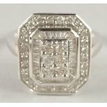 A 14CT WHITE GOLD SQUARE SHAPED DIAMOND RING.