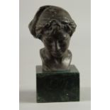 A BRONZE BUST HEAD OF A BOY. 3.5ins high on a marble base.