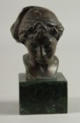 A BRONZE BUST HEAD OF A BOY. 3.5ins high on a marble base.