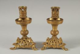 A PAIR OF 18TH CENTURY BRONZE AND GILT CLASSICAL CANDLESTICKS. 5ins high.