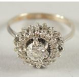 A 14CT WHITE GOLD DIAMOND CLUSTER RING.
