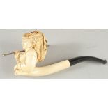 A MEERSHAUM PIPE CARVED AS A YOUNG LADY carrying a parasol. 9cm long, 7cm deep, with amber