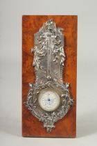 A SILVERED BAROMETER on a wooden base. 10ins x 4.5ins.