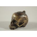 A RARE POSSIBLY 17TH CENTURY DUTCH BRASS POMANDER formed as a skull with fitted up lid. 2.5ins long,