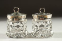 A PAIR OF SILVER TOP GLASS JAM POTS. Birmingham 1925 and A TEA STRAINER STAND and stand. (4).