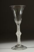 A GEORGIAN GLASS with inverted plain bell shaped bowl and air twist stem with knop. 7ins high.