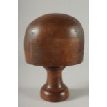 A MILLINER'S WOODEN HAT STAND