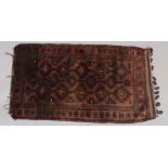 A PERSIAN LOOPED RUG/ CUSHION. 46ins x 26ins.