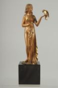 DEMETRE CHIPARUS (1886 - 1947) THE PARROT GIRL. A gilt bronze of a young lady standing, holding a