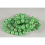 A GOOD STING OF LARGE JADE BEADS. 33ins long.