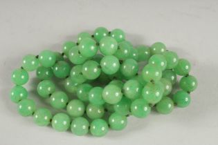 A GOOD STING OF LARGE JADE BEADS. 33ins long.