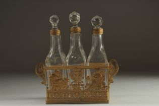 A GOOD FRENCH GILT METAL THREE BOTTLE LIQUEUR SET.