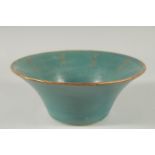 A CHINESE TURQUOISE GLAZE BOWL with gilt characters. 21.5ins diameter.