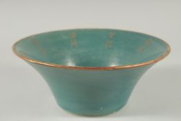 A CHINESE TURQUOISE GLAZE BOWL with gilt characters. 21.5ins diameter.