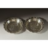 A PAIR OF CIRCULAR SILVER DISHES , 10ins diameter. Birmingham 1925. Weight 14ozs.