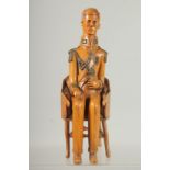 A RARE 19TH CENTURY CARVED BOXWOOD FIGURE OF NAPOLEON sitting in a chair. 9ins high.