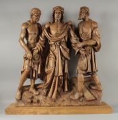 A GOOD LARGE CARVED WOOD RELIGIOUS GROUP OF THREE FIGURES. 27ins high.