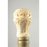 A WALKING STICK with carved bone and mother of pearl handle.