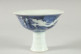 A Chinese blue and white decorated porcelain stem cup. 5ins diameter.