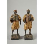 A GOOD PAIR OF 19TH CENTURY COLD PAINTED ARAB FIGURES. 9ins high.