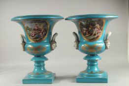 A LARGE PAIR OF SEVRES DESIGN BLUE TWO HANDLED URN SHAPED VASES with classical scenes. 18ins high.