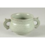 A CHINESE CLEADON CRACKLE GLAZE TWIN HANDLED CENSER. 15cm wide.