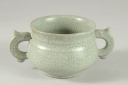 A CHINESE CLEADON CRACKLE GLAZE TWIN HANDLED CENSER. 15cm wide.