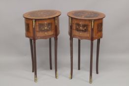 A PAIR OF LOUIS XVITH STYLE INLAID OVAL BEDSIDE TABLES with three drawers on slender curving legs.