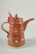 A Chinese pottery ewer, red glazed with gilded decoration. 9ins high.