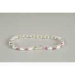 A SILVER RUBY AND OPAL LINE BRACELET.