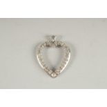 A 14CT WHITE GOLD AND DIAMOND HEART SHAPED PENDANT.