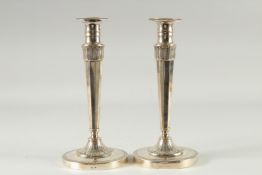 A PAIR OF CONTINENTAL SILVER CANDLESTICKS on circular bases. 10ins high.