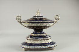 A GOOD SEVRES DESIGN DARK BLUE OVAL TUREEN, COVER AND STAND with cupid finial. 14ins high.