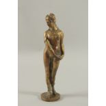 A GOOD HEAVY CAST BRONZE GRAND TOUR STANDING NUDE on a circular base. 10ins high.