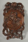 A GOOD CARVED OAK PANEL with roundel, shell and ribbons. 20ins x 12ins.