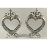 A PAIR OF SILVERED METAL HEART SHAPED LANTERNS. 19ins high.