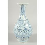 A CHINESES BLUE AND WHITE OCCTANGONAL YUHUCHIMPING VASE, painted with panels of flora. 28ins high.