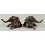 A PAIR OF BRONZE ELEPHANT HEADS. 5ins long.