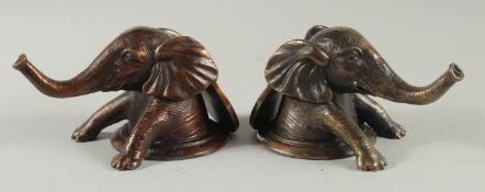 A PAIR OF BRONZE ELEPHANT HEADS. 5ins long.