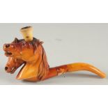 A GOOD MEERSCHAUM CHEROOT HOLDER carved as two horses' heads. 7cm long, 7cm deep with amber mouth