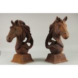 A PAIR OF CAST IRON HORSES' HEADS. 16ins high.