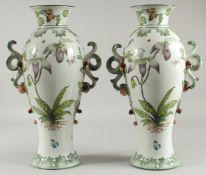 A LARGE PAIR OF SEVRES DESIGN WHITE GROUND PORCELAIN TWO HANDLED VASES painted with flowers with
