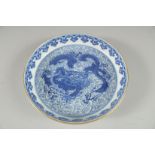 A CHINESE BLUE AND WHITE DRAGON SAUCER DISH. 17cm diameter.