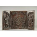 A VERY EARLY, POSSIBLY GERMAN ,CARVED OAK TRIPTYCH. The centre panel, 19ins x 17ins, Christ and